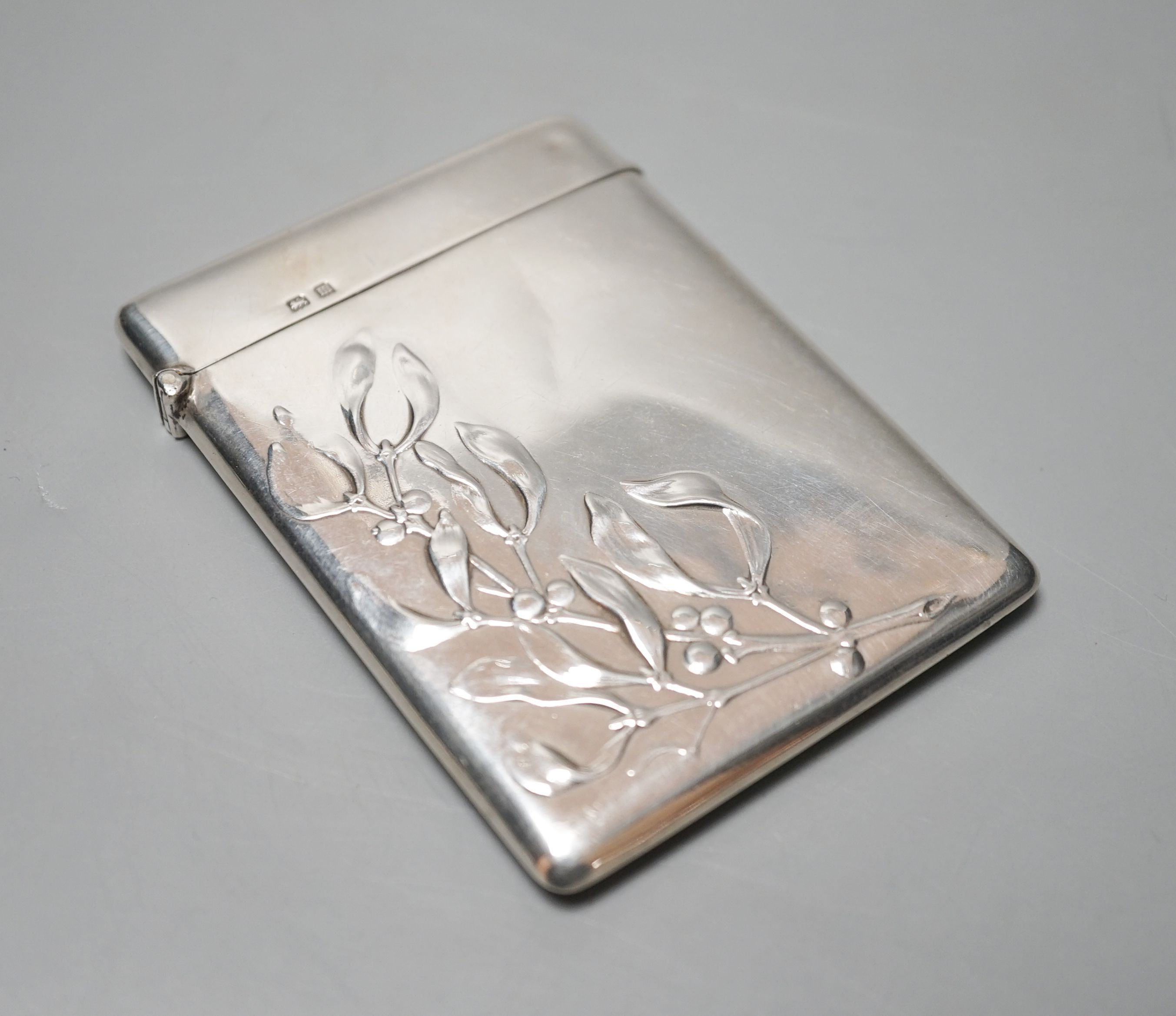 A George V silver card case embossed with mistletoe, Birmingham, 1911, 89mm.